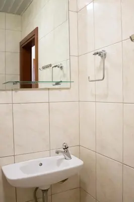 a bathroom with a sink and a mirror at SOHO CITY Grunevs apartments 2 in Bar