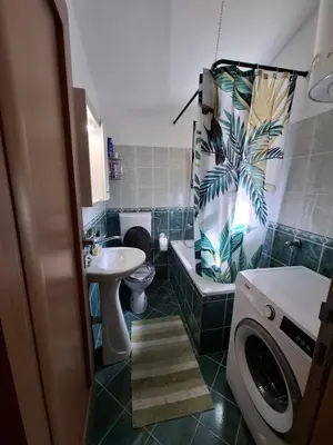 a bathroom with a sink and a toilet and a tub at Nina Apartment in Škaljari