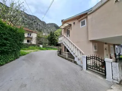 an empty street next to a building with a staircase at Nina Apartment in Škaljari