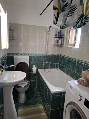 a bathroom with a toilet and a tub and a sink at Nina Apartment in Škaljari