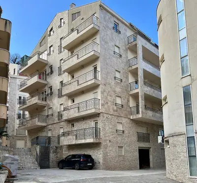 a car parked in front of a building at Salt & Stone Apartment in Sveti Stefan