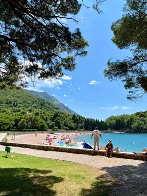 a group of people on a beach near the water at Salt & Stone Apartment in Sveti Stefan