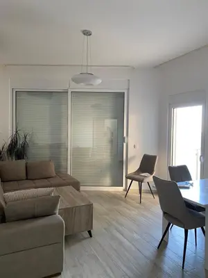 a living room with a couch and a table at Biser mora in Dobra Voda