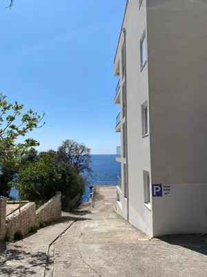 a building with the ocean in the background at Biser mora in Dobra Voda