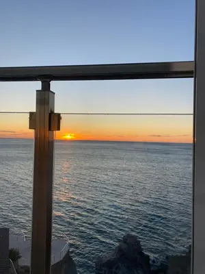 a view from a window of the ocean at sunset at Biser mora in Dobra Voda