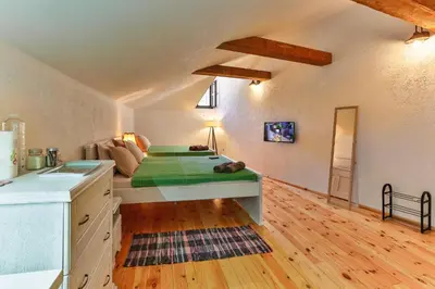 a bedroom with a bed and a sink in a room at Olea Apartments in Stari Bar