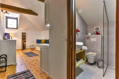 a bathroom with a sink and a toilet in a room at Olea Apartments in Stari Bar