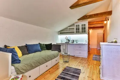 a living room with a couch and a kitchen at Olea Apartments in Stari Bar