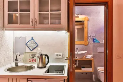 a small kitchen with a sink and a refrigerator at Olea Apartments in Stari Bar