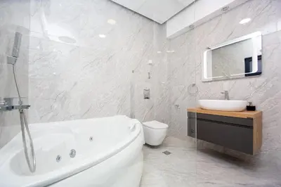 a bathroom with a tub and a sink and a toilet at Villa Aurora Azure - Luxury Infinity Pool Resort in Katun