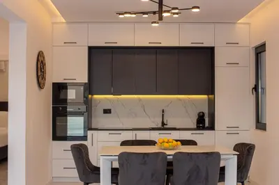 a kitchen with a table and chairs in a room at Villa Aurora Azure - Luxury Infinity Pool Resort in Katun