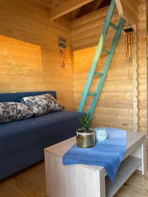 a room with a bed and a ladder and a table at Zvoncica, Ada Bojana in Ada