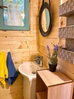a small bathroom with a sink and a mirror at Zvoncica, Ada Bojana in Ada