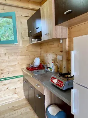 a small kitchen with a sink and a refrigerator at Zvoncica, Ada Bojana in Ada