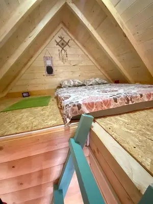 a bed in the middle of a room in a tree house at Zvoncica, Ada Bojana in Ada