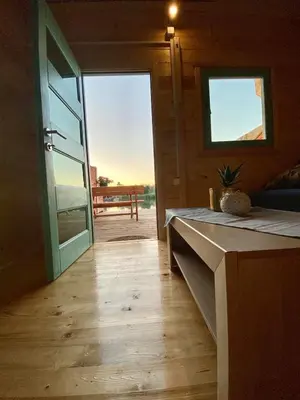 an open door to a room with a table and a bench at Zvoncica, Ada Bojana in Ada