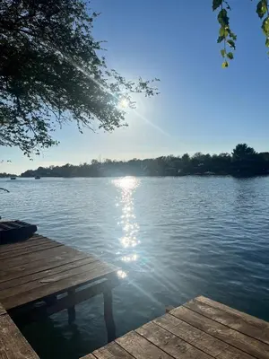 a view of a lake with a wooden dock at Zvoncica, Ada Bojana in Ada