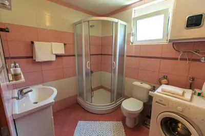a bathroom with a shower and a toilet and a sink at Yu&li Rose Apartments Adriatic in Bar