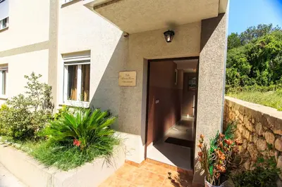 a door to a building with plants in front of it at Yu&li Rose Apartments Adriatic in Bar