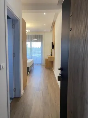 a room with a bathroom with a tub and a door at Morea Residence in Ulcinj