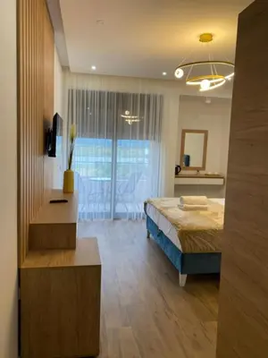 a bedroom with a bed and a large window at Morea Residence in Ulcinj