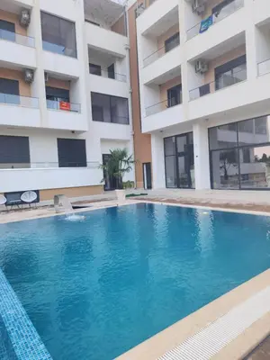 a swimming pool in front of a building at Morea Residence in Ulcinj