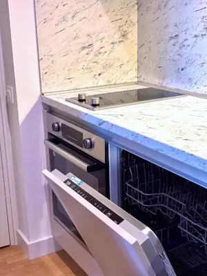 a dishwasher in a kitchen with a counter top at Luxe Beachfront Stay in Bečići with Pool in Budva