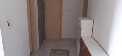 a hallway with a white refrigerator in a room at Apartman Marko in Podgorica