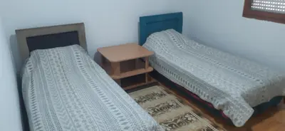 two beds sitting next to each other in a room at Apartman Marko in Podgorica
