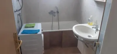 a bathroom with a sink and a shower and a toilet at Apartman Marko in Podgorica
