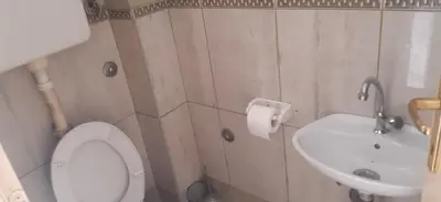a bathroom with a toilet and a sink at Apartman Marko in Podgorica