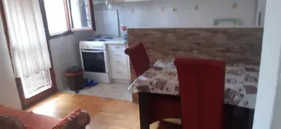 a kitchen with a table and a stove at Apartman Marko in Podgorica