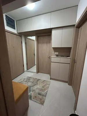an empty kitchen with white cabinets and a rug at Urban Apartment Master Quart in Podgorica