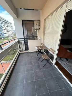 a balcony of a condo with chairs and a table at Urban Apartment Master Quart in Podgorica