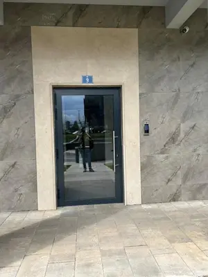 a man standing in the doorway of a building at Urban Apartment Master Quart in Podgorica