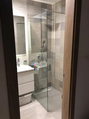 a bathroom with a glass shower and a sink at Urban Apartment Master Quart in Podgorica