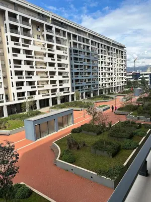 a large apartment building with a courtyard in front of it at Urban Apartment Master Quart in Podgorica