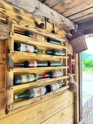 a bunch of wine bottles in a wine cellar at Camp River in Virpazar