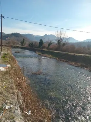 a river with trash in the middle of it at Camp River in Virpazar