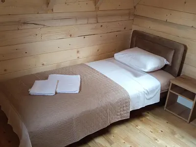 a bedroom with a bed with two towels on it at Camp River in Virpazar