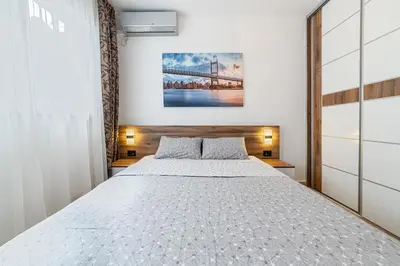 a bedroom with a large bed and a bridge at Aurora Apartment 1 with Parking in Budva