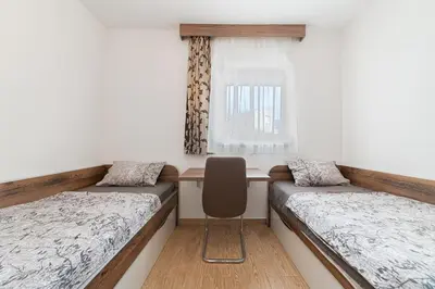 a room with two beds and a window at Aurora Apartment 1 with Parking in Budva
