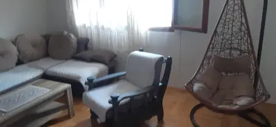 a living room with a couch and a chair at Porodična kuća in Podgorica