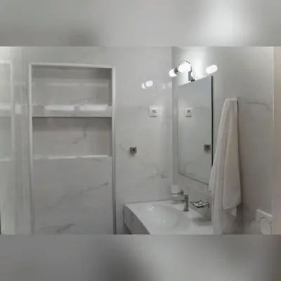 a white bathroom with a sink and a mirror at Urban apartments Sutomore in Sutomore
