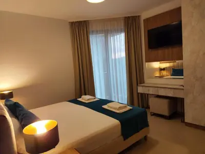 a hotel room with a bed and a fireplace at Urban apartments Sutomore in Sutomore