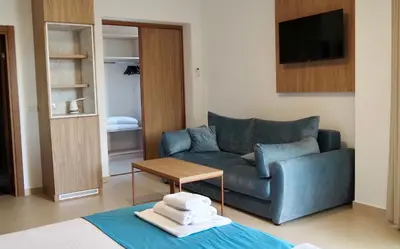 a living room with a couch and a table at Urban apartments Sutomore in Sutomore
