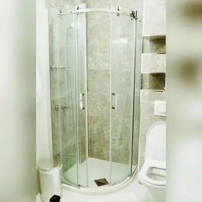a glass shower in a bathroom with a toilet at Urban apartments Sutomore in Sutomore