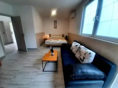 a living room with a couch and a bed at Apartman Šušanj 2 in Bar