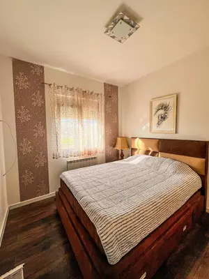 a bedroom with a bed and a window at Charming Countryside Villa with Garden & Terrace near Skadar Lake in Berislavci