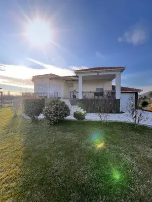 a house with a lawn in front of it at Charming Countryside Villa with Garden & Terrace near Skadar Lake in Berislavci